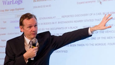 Founder of the Wikileaks website Julian Assange displays a page from the Wikileaks page on October 23, 2010 during a press conference at the Park Plaza hotel in central London. 