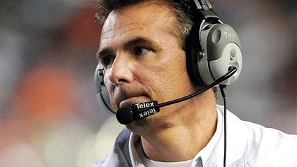 In this Oct. 16, 2010, file photo, Florida's Urban Meyer looks on during the first half against Mississippi Sate in an NCAA college football game in Gainesville, Fla. Meyer is stepping down as coach after the Gators appearance in the Outback Bowl. In a st 