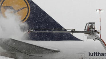A Lufthansa plane is de-iced at Frankfurt Rhein Main airport, in Frankfurt, Germany, Sunday, Dec. 19, 2010. 