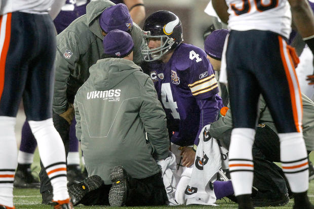 Quarterback Brett Favre #4 of the Minnesota Vikings is attended to after being sacked 