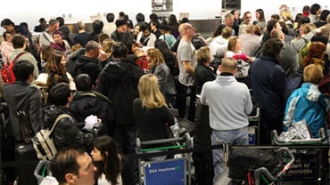 Passengers wait in the Departures area of Terminal 3 at Heathrow Airport as travel chaos continues due to the adverse weather, Tuesday, Dec. 21 2010. 