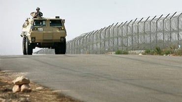 In this Sunday, July 29, 2007 file photo, an Egyptian army armored personnel carrier patrols the Egyptian side of the border with the Gaza strip, near the Rafah border crossing in Egypt. (AP)  
