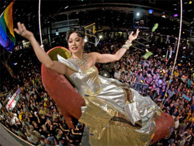 "Sushi," portrayed by female impersonator Gary Marion, dangles high above New Year's Eve revelers in a giant reproduction of a woman's high heel at the Bourbon Street Pub late Friday, Dec. 31, 2010, in Key West, Fla. 
