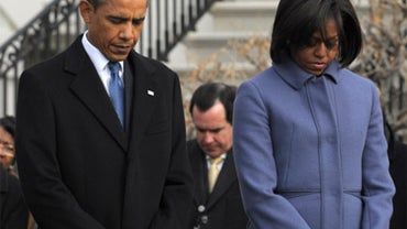 President Barack Obama, first lady Michelle Obama, and government employees observe a moment of silence on South Lawn  