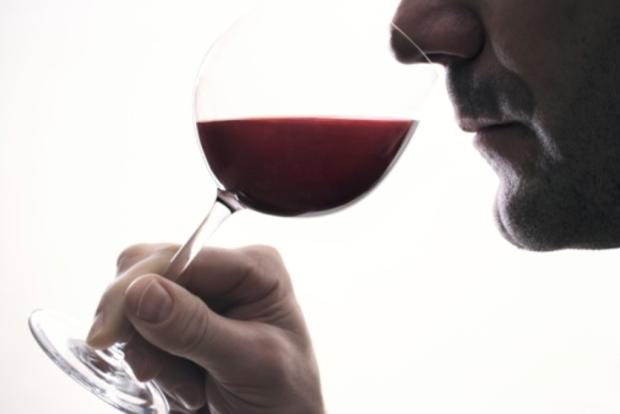 Man drinks red wine in glass 