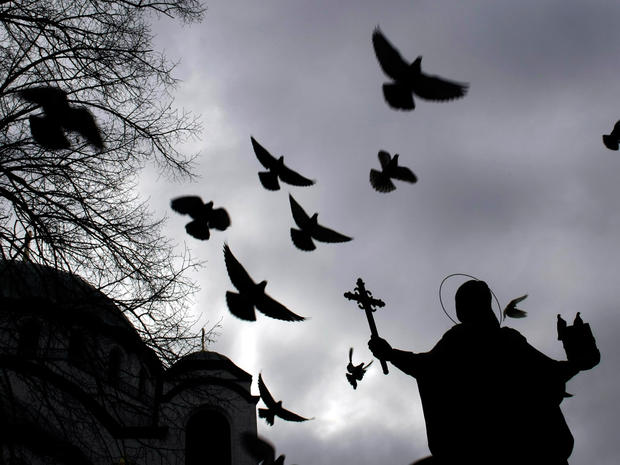 Birds fly past a monument to St. Sava, the first archbishop of the autocephalous Serbian Orthodox Church, in central Belgrade, Serbia. 