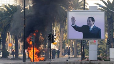 Smoke rises from fire left after clashes between security forces and demonstrators in Tunis on January 14, 2011 after Tunisian President Zine El Abidine Ben Ali's address to the nation. 