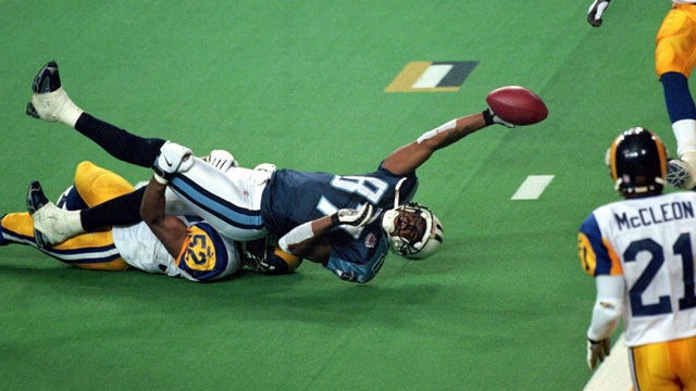 Kevin Dyson of the  Titans reaches for the end zone with the ball 