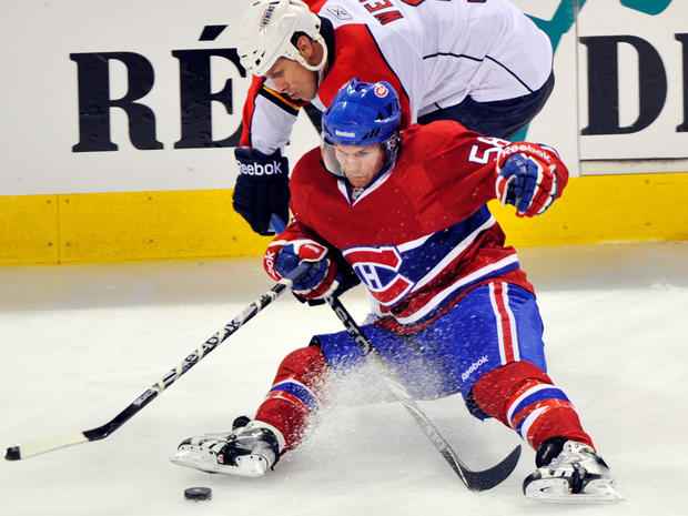 Canadiens center David Desharnais (58) is knocked to the ice by Panthers center Stephen Weiss 