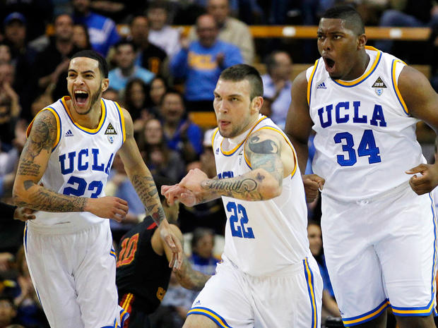 UCLA's Joshua Smith, right, celebrates after dunking the ball 