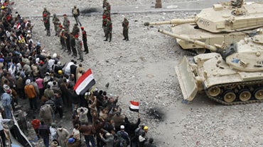 Egyptian anti-government demonstrators face army tanks in Cairo's Tahrir square on February 05, 2011, as Egyptians gather for the 12th consecutive day calling for the end to President Hosni Mubarak's regime. 