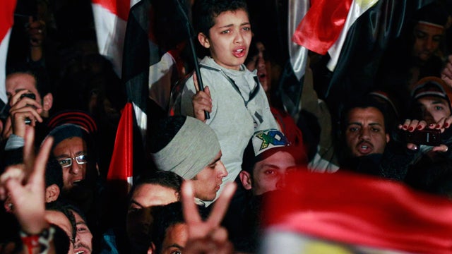 Egyptian boy cries with emotion as he and others celebrate 