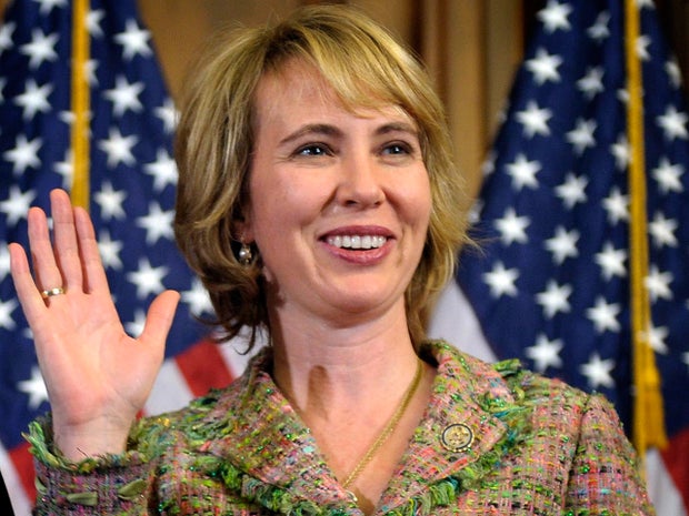 Rep. Gabrielle Giffords takes part in a reenactment of her swearing-in 
