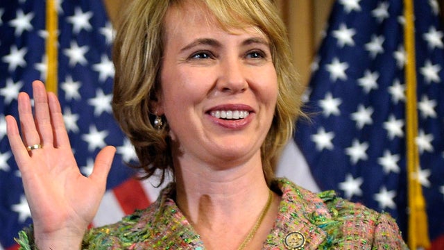 Rep. Gabrielle Giffords takes part in a reenactment of her swearing-in 