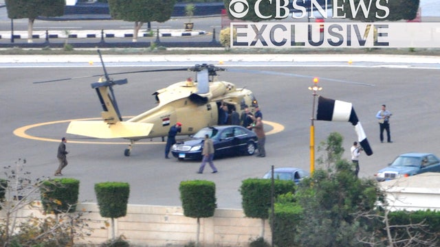 Hosni Mubarak waves as he boards a helicopter while leaving Cairo, Egypt 