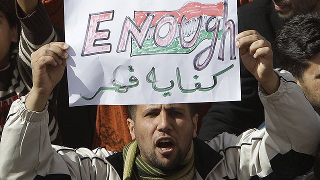 A Libyan protester holds up a sign against Libyan Leader Moammar Gadhafi during a demonstration. 