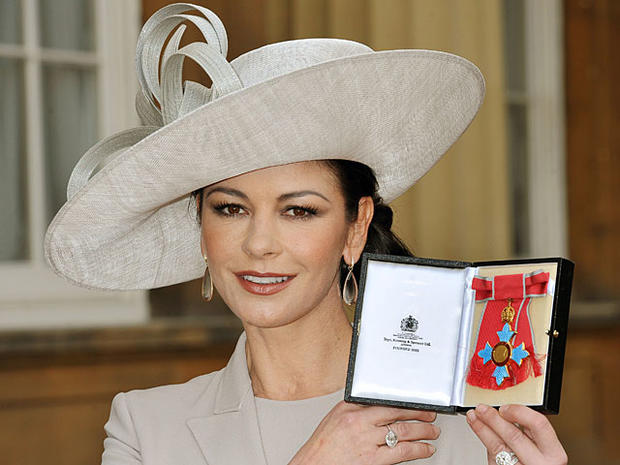 British born actress Catherine Zeta-Jones poses for photographs after receiving her Commander of the Order of the British Empire (CBE) from Britain's Prince Charles at Buckingham Palace in central Lon... Read moreBy: JOHN STILLWELL 