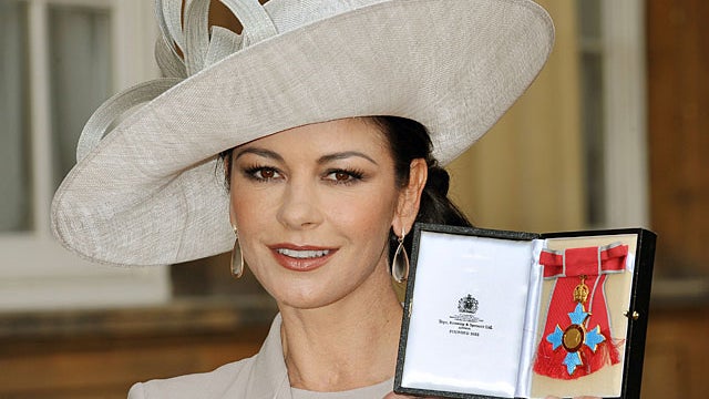 British born actress Catherine Zeta-Jones poses for photographs after receiving her Commander of the Order of the British Empire (CBE) from Britain's Prince Charles at Buckingham Palace in central Lon... Read moreBy: JOHN STILLWELL 