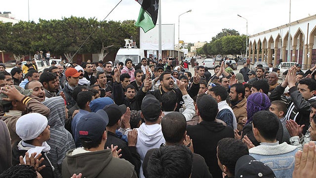 In this photo released by China's Xinhua News Agency, people attend a protest in the eastern Libyan town of Derna. 