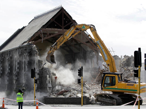 Heavy machinery demolishes an earthquake damaged church 