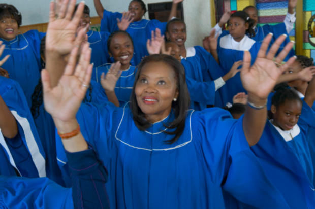 Congregation of Gospel Singers With Raised Hands Singing in a Church Service 