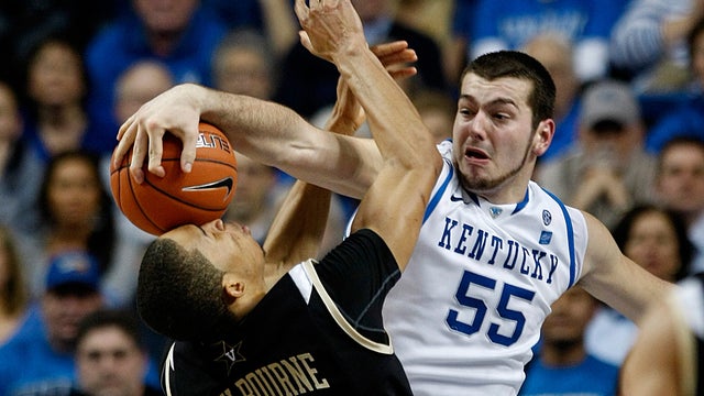 Kentucky's Josh Harrellson (55) smashes the ball into the face of Vanderbilt's Lance Goulbourne 