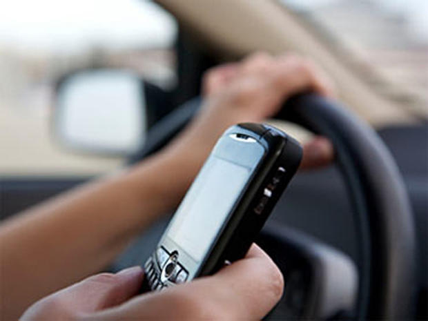 A person is seen texting while driving. 