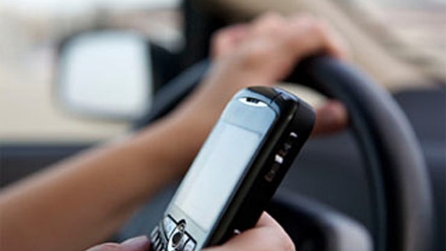 A person is seen texting while driving.  
