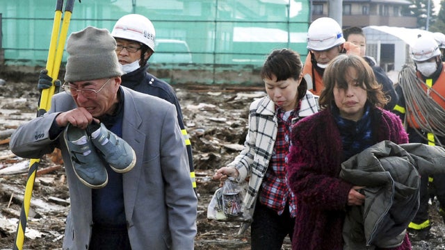 Residents walk through destruction in Sendai 