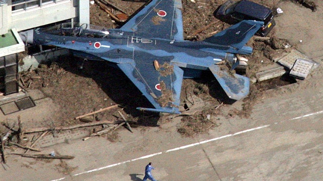 Workers search for survivors, and bodies, amid Japan quake rubble 