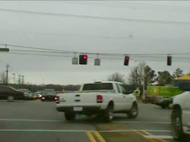 Two escaped murder suspects drive their stolen pick-up through a red light as Mississippi and Tennessee police give chase, March 14, 2011 