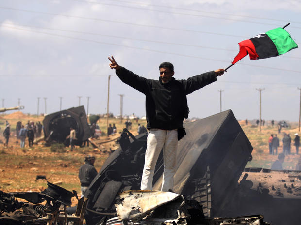 A Libyan rebel waves the rebellion flag 