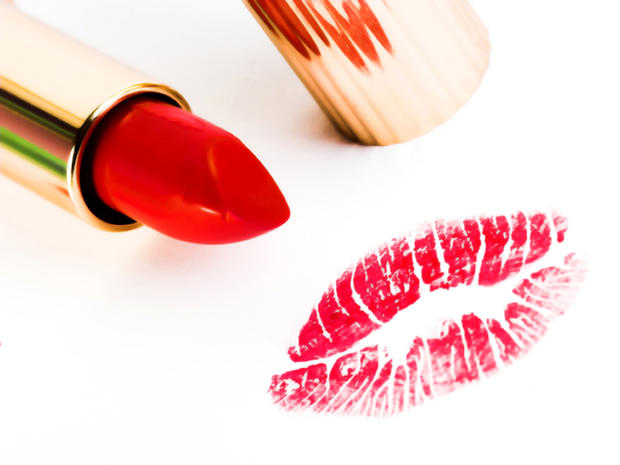 Lipstick with kiss on white background 