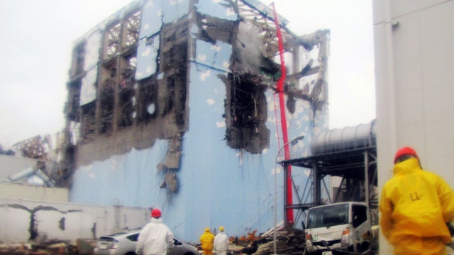 Workers spray water on reactor Number 4 at Fukushima Dai-ichi nuclear plant 