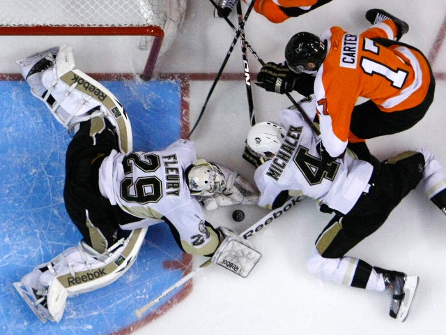 Jeff Carter battles for the puck with Zbynek Michalek 