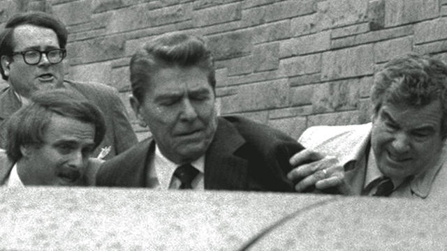 President Ronald Reagan is shoved into the presidential limousine by Secret Service agents after being shot outside a Washington hotel March 30, 1981. 