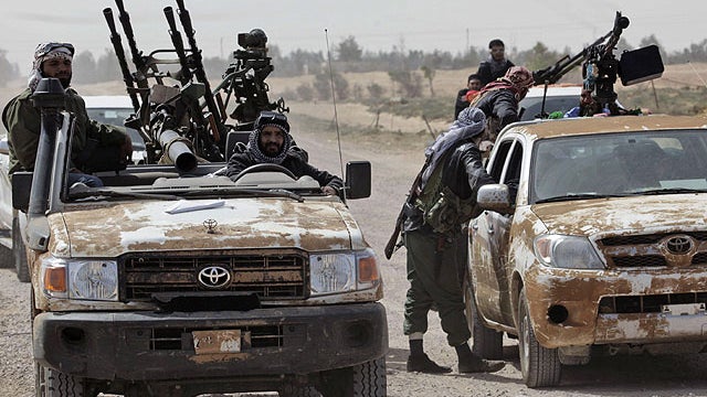 Libyan rebels gather on the main road while retreating back east, at the outskirts of the town of al-Agila, Libya, March 30, 2011.  