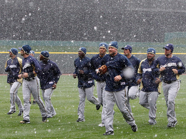 Brewers players jog in the snow 