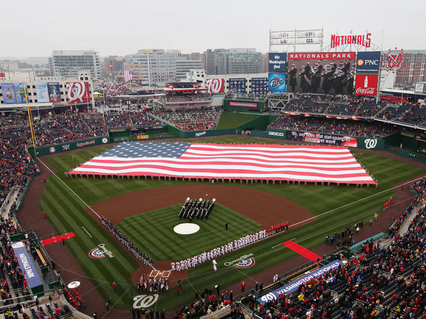 Braves and Nationals stand on the field during the national anthem 
