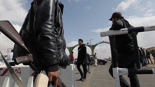 Libyan rebels close the western gate of Ajdabiya, Libya, Friday, April 1, 2011, as limited movement is being permitted across the frontier. The western gate is closed Friday for journalists and civilians trying to reach the front line.  