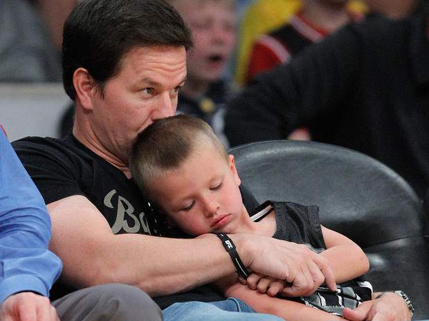 ctor Mark Wahlberg kisses his son while watching the Lakers vs. the Mavericks. 