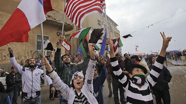 Youths carry flags of the US, France, Italy, and other nations to show their support, after Friday prayers on the corniche in Benghazi, Libya, April 1, 2011.  
