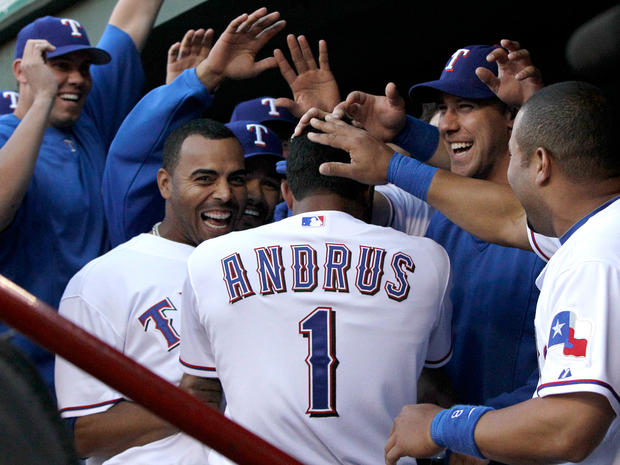 Elvis Andrus is congratulated following his solo home run  
