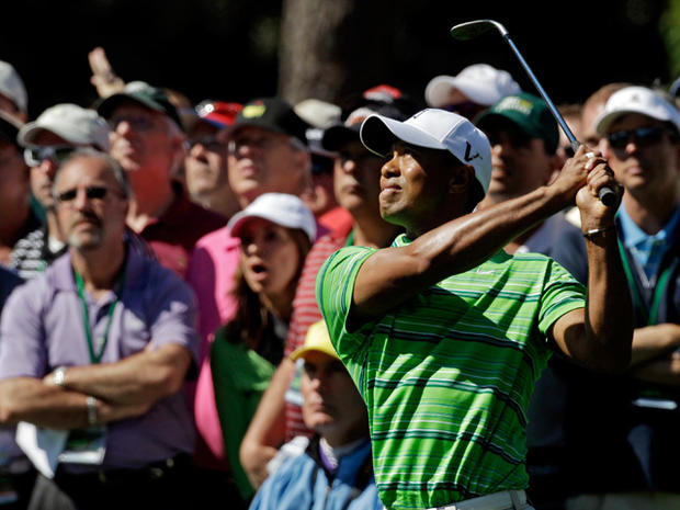 Tiger Woods watches his approach shot 