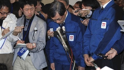 Tokyo Electric Power Co. (TEPCO) President Masataka Shimizu, center, bows during a news conference held at the Fukushima prefectural government office in Fukushima, northeastern Japan, Monday, April 11, 2011. Fukushima governor declined to meet Shimizu wh 
