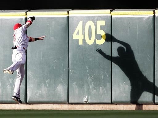 Josh Hamilton reaches to catch a fly ball  