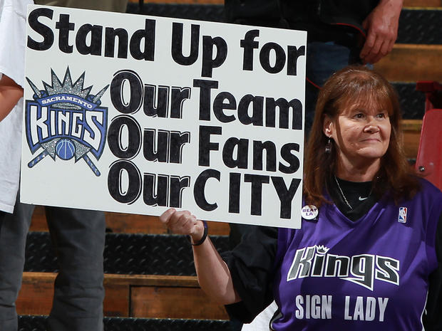 Kings hold up a sign 