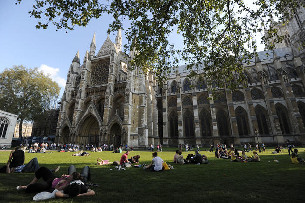 Tourists relax in the gardens outside Westminster Abbey on April 22, 2011, before the royal wedding between Britain's Prince William and his fiancee Kate Middleton at Westminster Abbey on April 29, 2011. 
