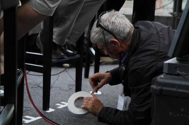 CBS Crew member uses  tape to block interview positions in London on April 28, 2011. 