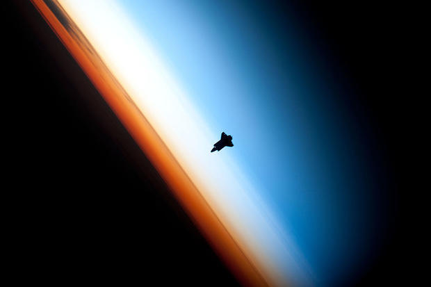 Over the South Pacific Ocean off the coast of southern Chile at an altitude of 183 miles, the Space Shuttle Endeavour is seen here on February 9, 2010, silhouetted against the Earth as it prepares to dock with the International Space Station during missio 